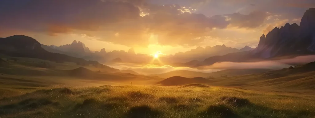 a serene landscape unfolds at sunrise, with golden light illuminating a misty valley, framed by majestic mountains shrouded in gentle clouds.