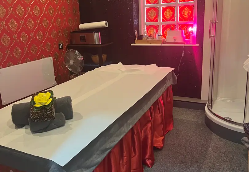 Treatment room with red and gold Thai wallpaper